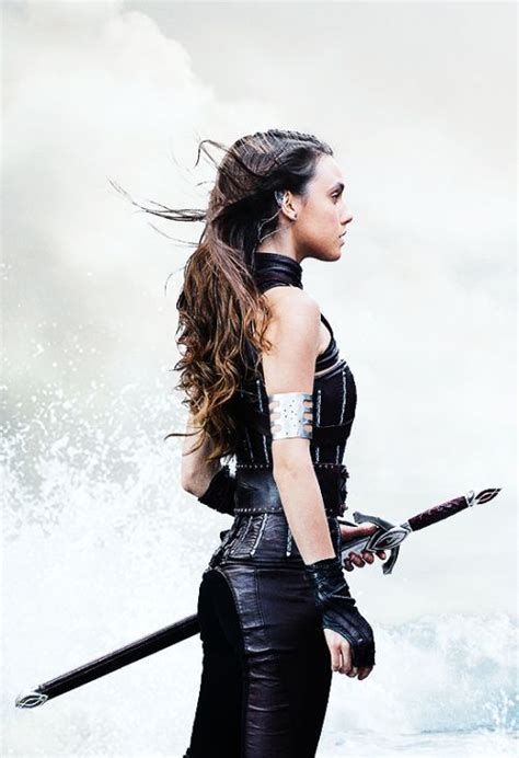 the cover to cruel crown, featuring a woman in black leather outfit holding two swords