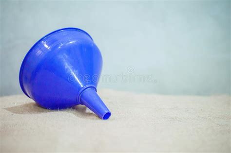 Blue Plastic Funnel on Table on Blue Background Stock Photo - Image of funnel, pink: 220335720