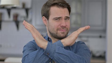 Portrait of Young Man Saying No with Cross Arm Sign Stock Image - Image ...