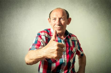 Premium Photo | Portrait of the funny senior man doing thumbs up