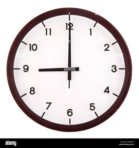 Classic analog clock pointing at 9 o'clock, isolated on white background Stock Photo - Alamy