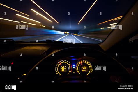 Driver view at speeding car dashboard and motorway at night Stock Photo: 138034944 - Alamy