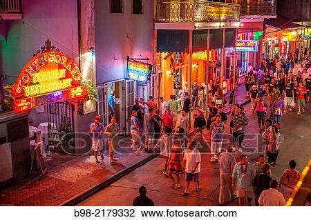 Tourists crowd Bourbon Street in New Orleans? French Quarter at twilight, looking for nightlife ...