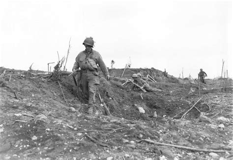 an old black and white photo of soldiers in the field