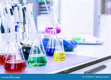 Chemical Analysis, Pharmacology and Laboratory Concept. Flasks with Colored Liquid Reagents in a ...