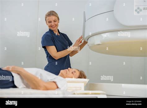 Radiologist controls MRI or CT or PET Scan with female patient ...