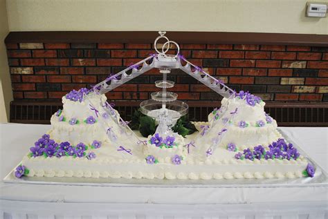 Wedding - Base of cake is 51" x 19" - 4 sheet cakes, with a 6" single layer in the front, and ...