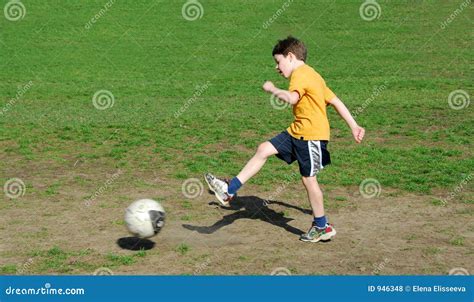 Boy kicking soccer ball stock photo. Image of recreation - 946348