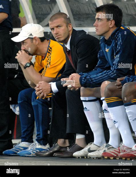 Sidelined by an ankle injury, L.A. Galaxy star David Beckham(center) watches the game from the ...