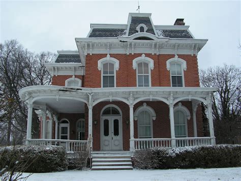 a large red brick house with white trim