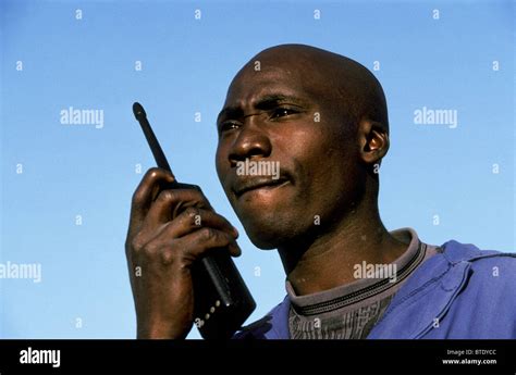 Game scout talking on a two way radio Stock Photo - Alamy