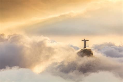 The statue of Christ the Redeemer is visible through the clouds above ...