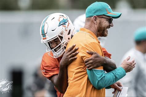 CAPTION THIS! Miami Dolphins QB Tua Tagovailoa and Quarterbacks coach Darrell Bevell embrace ...