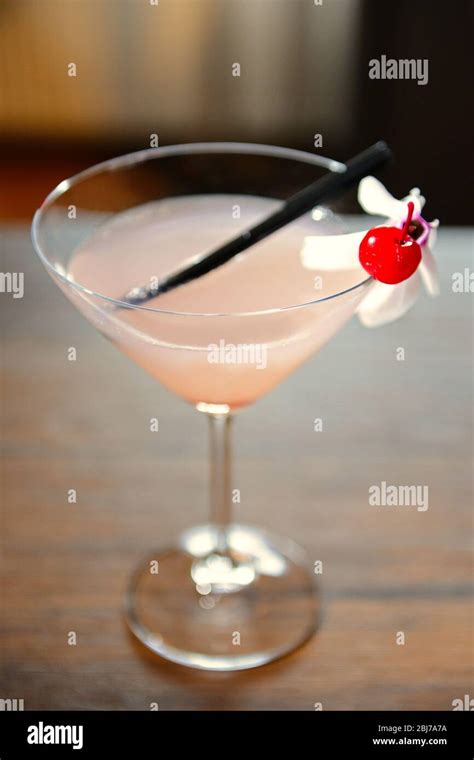 Glass of cocktail on bar background Stock Photo - Alamy