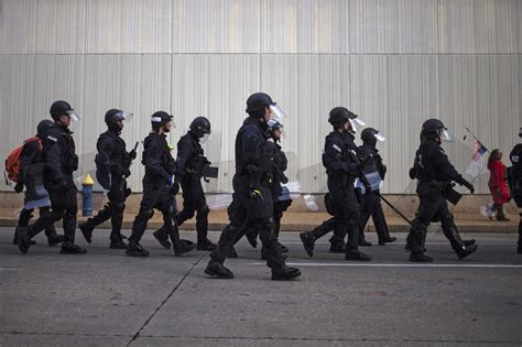 Police in riot gear march towards protestors, who were demanding ...