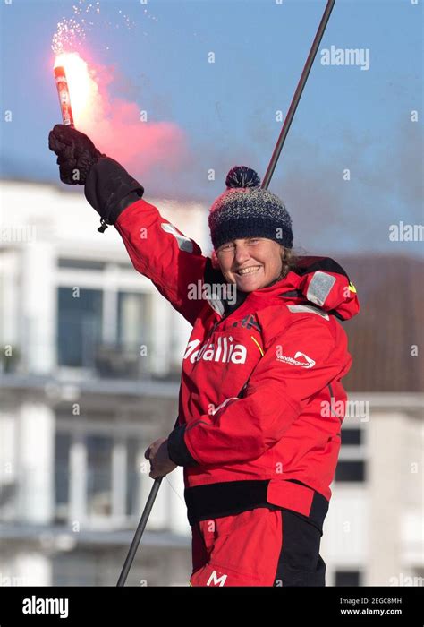 Pip Hare sets off a flare as she sails her boat Medallia into Poole, Dorset, after completing ...