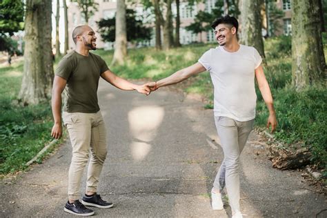 Two Men Holding Hands and Walking Together · Free Stock Photo