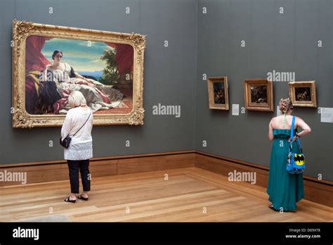 VISITORS LOOKING AT PAINTINGS IN EXHIBITION HALL IN JOHN PAUL GETTY MUSEUM GETTY CENTER LOS ...