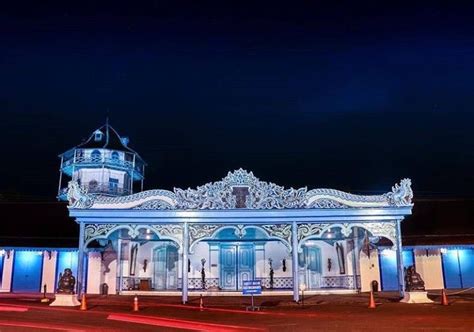 an old building lit up at night with blue lights