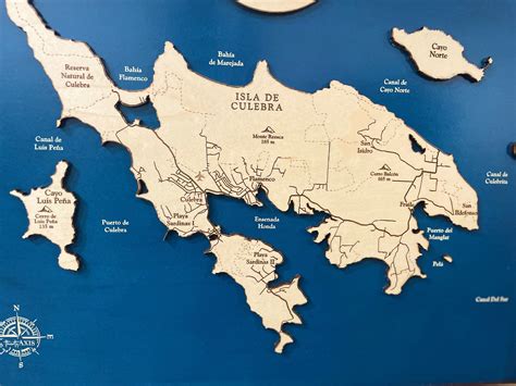 a wooden cutout map of the island of culebra, with all its major cities