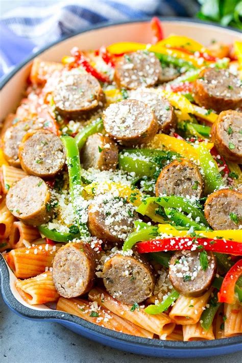 Sausage and pepper pasta with sliced Italian sausage, red and yellow bell peppers and gra ...