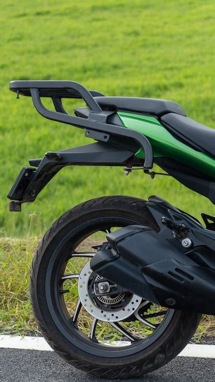 Green and Black Sports Bike on Green Grass Field · Free Stock Photo