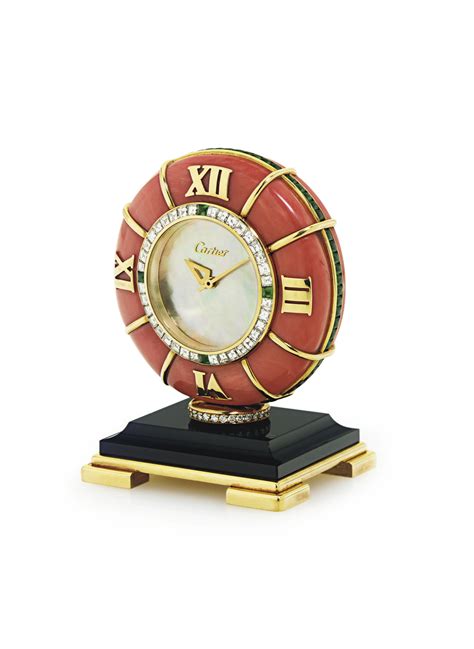 CARTIER. AN 18K GOLD, DIAMOND, EMERALD, CORAL, ONYX AND MOTHER-OF-PEARL DESK CLOCK , SIGNED ...