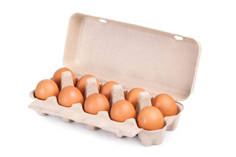 Premium Photo | Ten brown eggs in a carton package