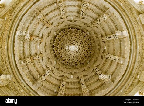 Horizontal close up of the carved marble corbelled ceiling rose inside the Adinath Jain Temple ...