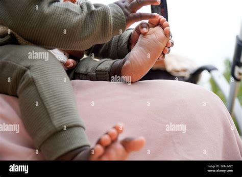 feet and hands of a black african baby playing Stock Photo - Alamy