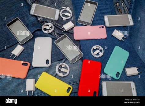 texture of mobile phone accessories on a denim background Stock Photo - Alamy