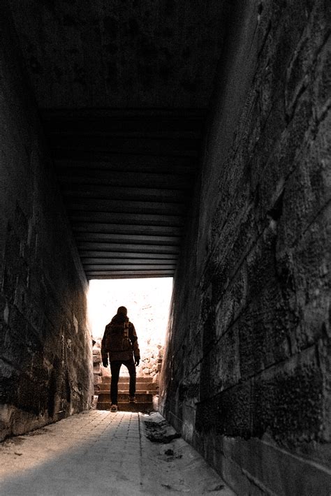 Silhouette of a Person Walking on a Grey Floor Tiles Beside White Cabinet in Dark Room · Free ...