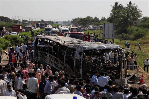 Bus crashes into a highway barrier and catches fire in southern India ...