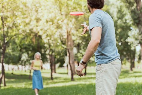 Young Couple Playing Frisbee in Park Stock Image - Image of handsome ...