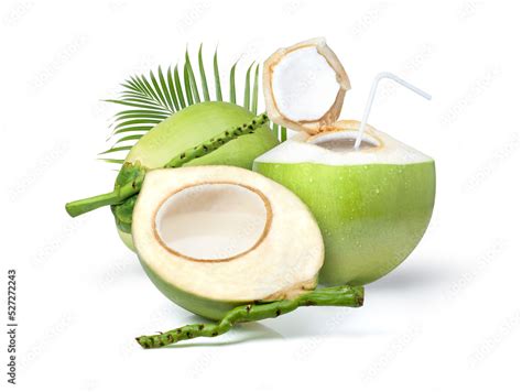 Young green coconut with coconut juice in half fruit and palm leaf isolated on white background ...