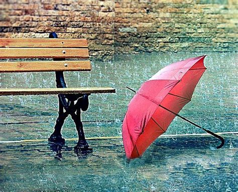 Red umbrella near a bench - Rainy day