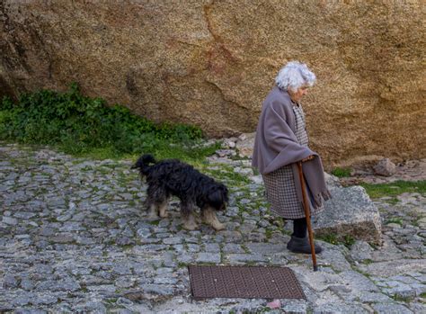 Old lady walking with her dog. Monsanto Portugal