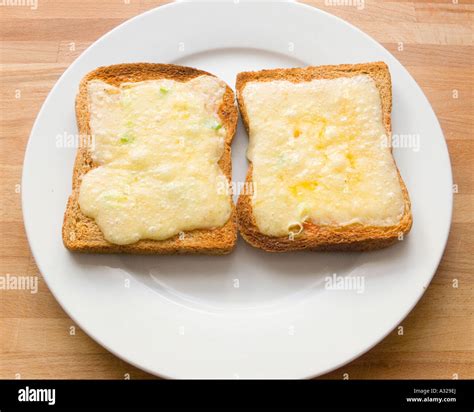 Cheese melt melted on wholemeal brown Toast bread on a plate grill ...