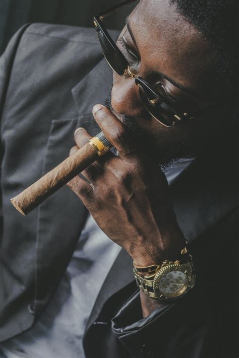 Crop stylish black businessman in sunglasses smoking cigar · Free Stock Photo