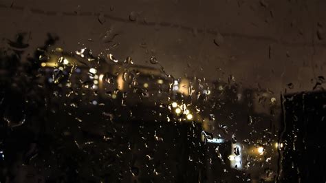 a view of the city through a window with raindrops 26413339 Stock Video at Vecteezy