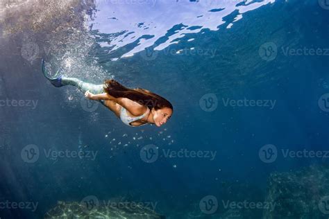 Mermaid swimming underwater in the deep blue sea 17367173 Stock Photo ...