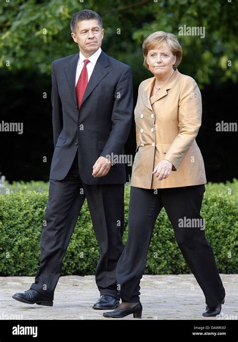 German Chancellor Angela Merkel (R) and her husband Joachim Sauer ...