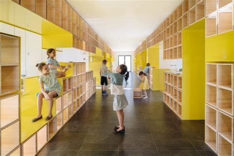 Walls with integrated furniture and yellow nooks encourage play in ...