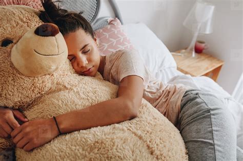 Girl sleeping on bed holding a teddy bear stock photo (159827) - YouWorkForThem