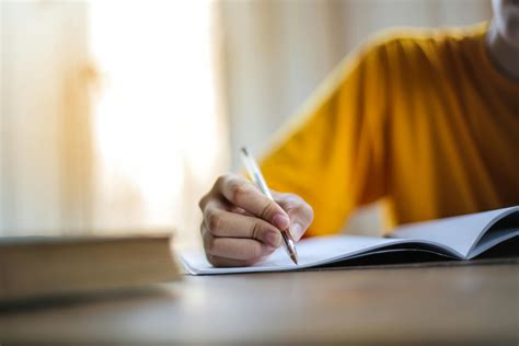 Selective Focus Photo of Person Writing · Free Stock Photo