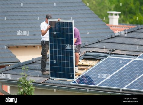 Installation of photovoltaic solar panels on roof of house, Germany ...