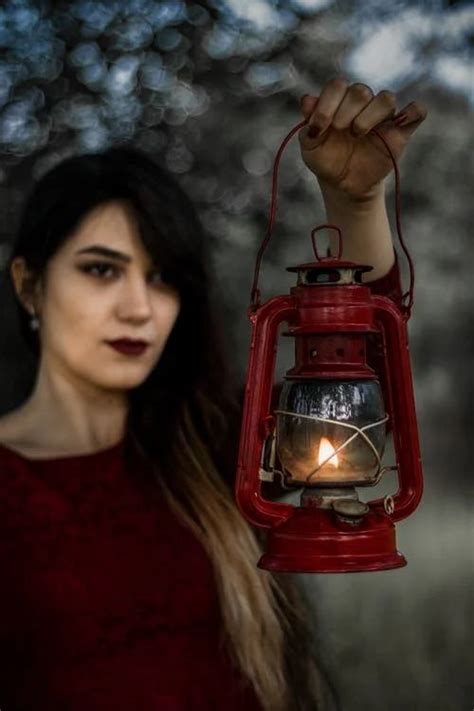 A Woman with a Red Kerosene Lamp
