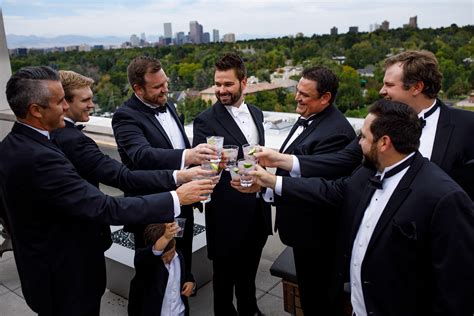 The groom and groomsmen toast from the rooftop at the Halcyon hotel in ...