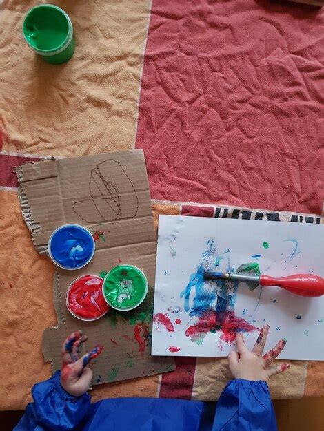 Premium Photo | Cropped hand of child drawing at table