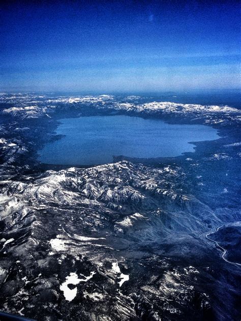 AERIAL VIEW OF BEAUTIFUL LAKE TAHOE SURROUNDED BY THE SNOW COVERED ...